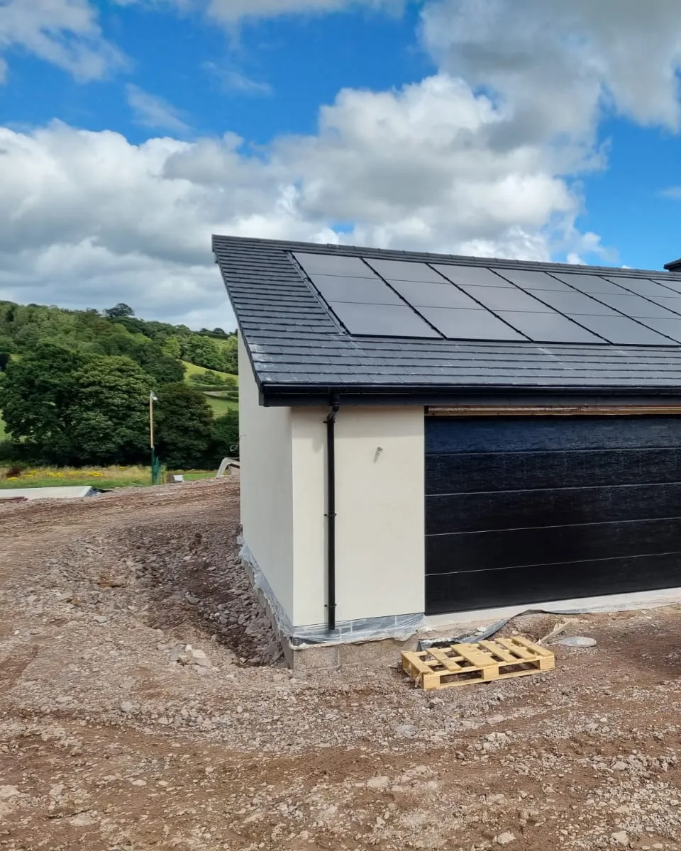 In-roof solar array on the new-build garage, set against Scottish countryside